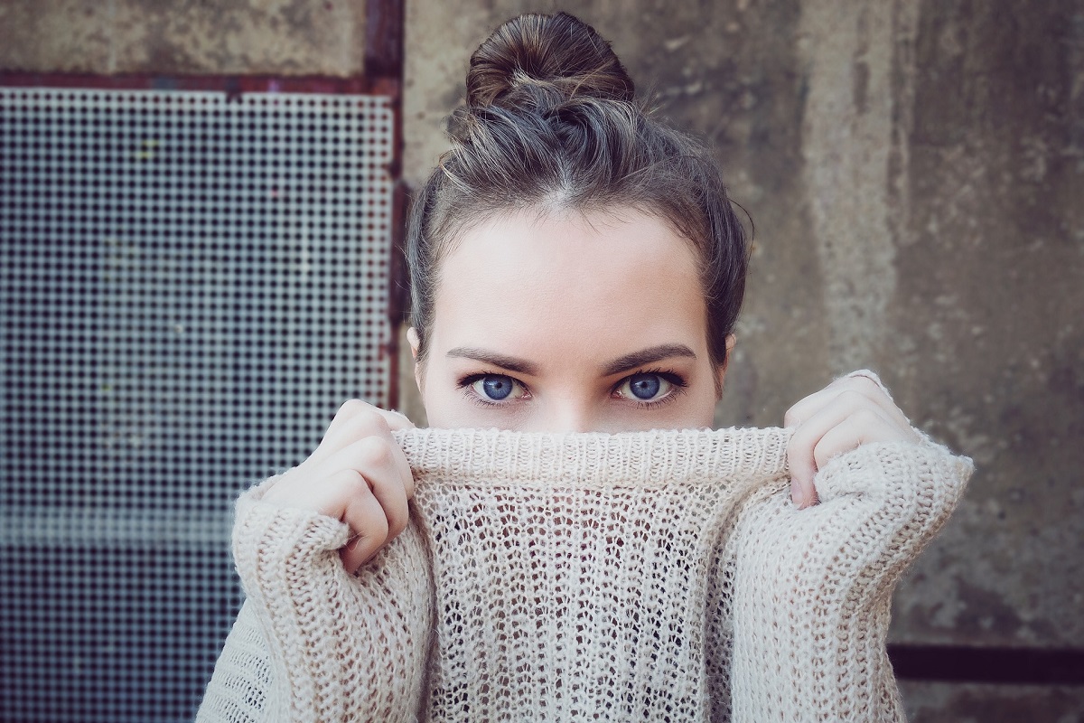 woman covering nose