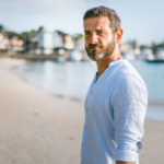 Man standing on the beach during the day.