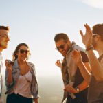 Group of men and women having fun together under the sun. Male enhancement.