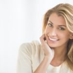 Happy Woman Sitting On Sofa